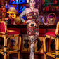 Woman in a patterned dress standing in a bar with colorful decor