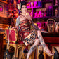 Woman with tattoos sitting in a bar with colorful decor