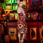 Woman with tattoos standing in a colorful bar setting