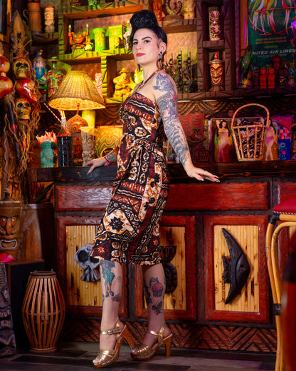 Woman with tattoos standing in a colorful bar setting