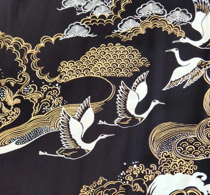 Traditional Japanese design with cranes, waves, and clouds on a black background