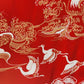 Decorative fabric with white cranes and gold patterns on a red background